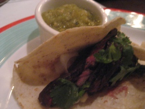 Pork Tacos al Carbon - Smoky and succulent served with tomatillo and roasted tomato salsas